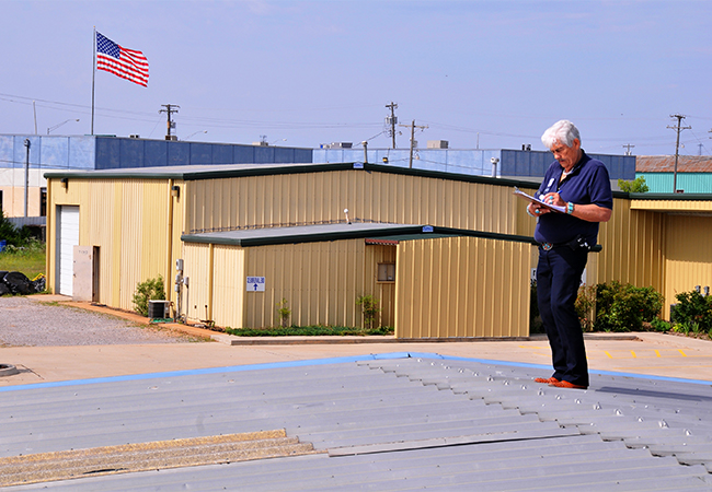 Person documents damages to a roof