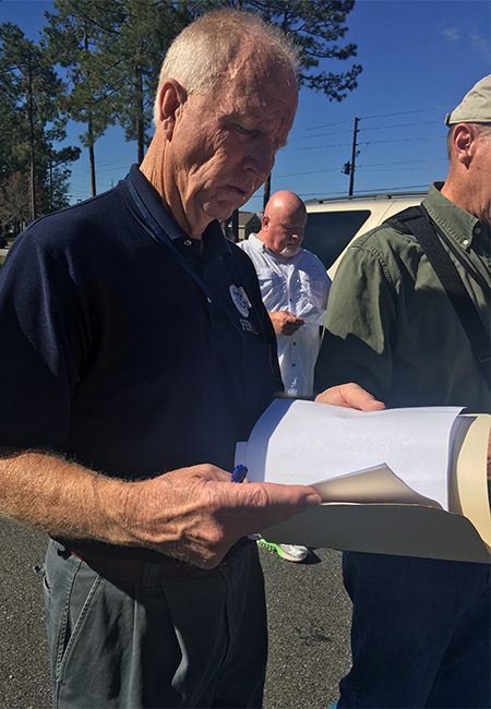 A FEMA employee verifies Applicant documentation at a damaged facility.