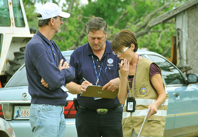 Preliminary Damage Assessment team evaluating damages and losses.