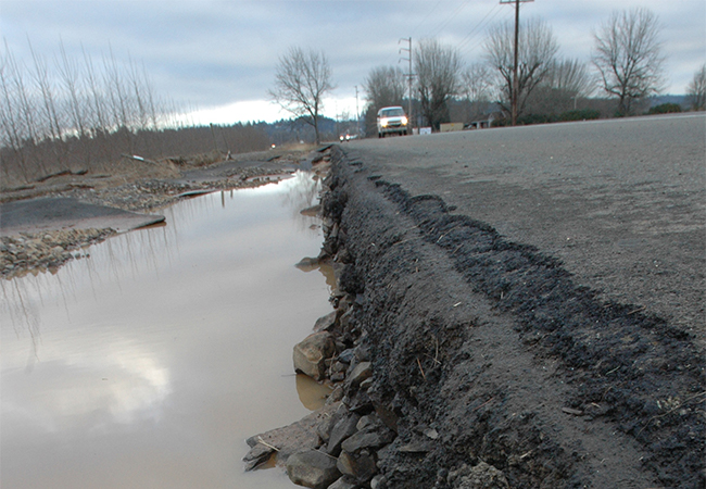 Extensive road damage caused by flooding.