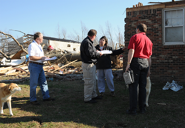 Inspection team assessing damage to home after disaster