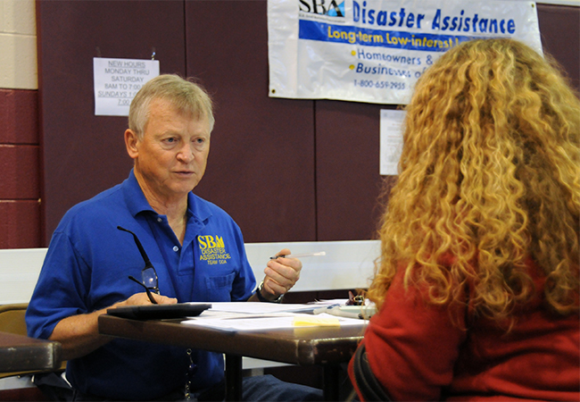 Representative from Small Business Administration speaking to an affected resident.