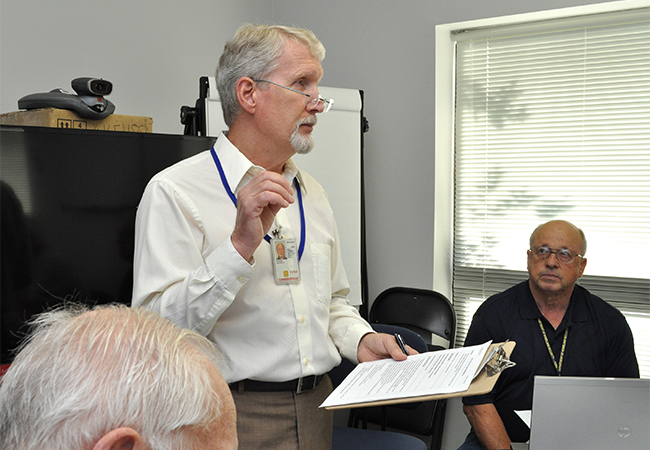 FEMA representative shares updated information with the team.