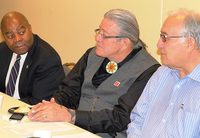 FEMA/EMI Officials and Tribal officials sitting together at a table during training.