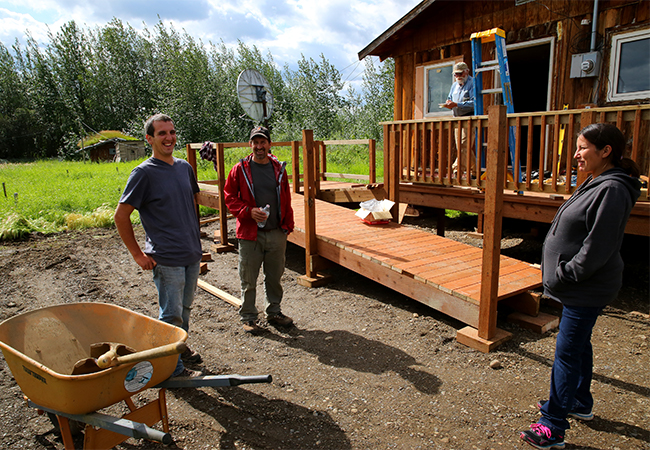 Tribal Chief meets with the volunteers at a home repair site