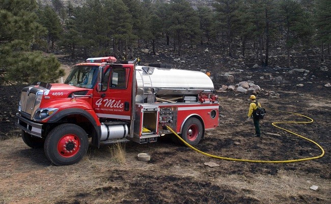 Four Mile Fire District Water works to mop up hot spots on the Old Stage Fire in Colorado with the fire truck they received through a FEMA fire mitigation grant.