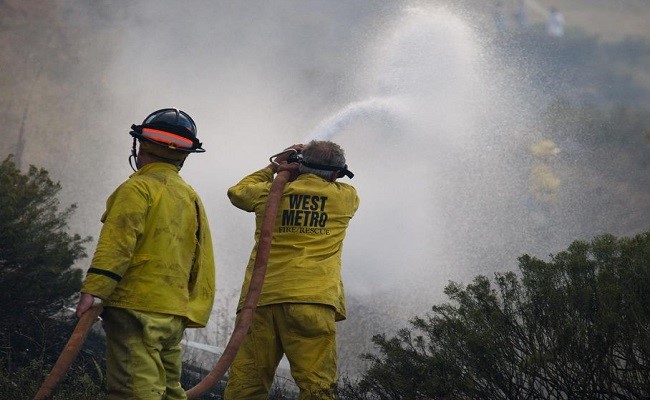 Wild land ground crews from West Metro fire district use hoses to work on taking control of the Green Mountain fire.