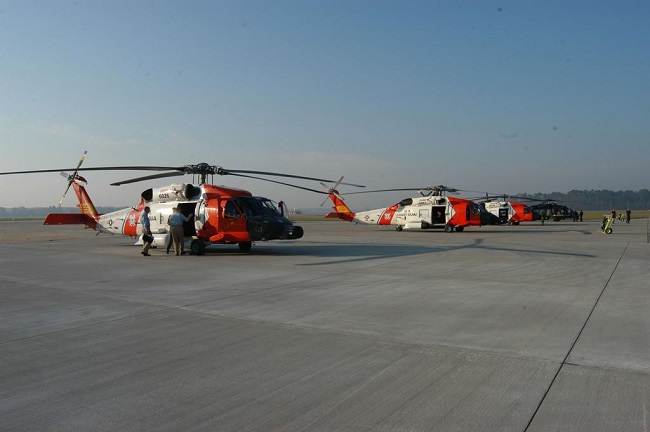 Three helicopters on an airfield