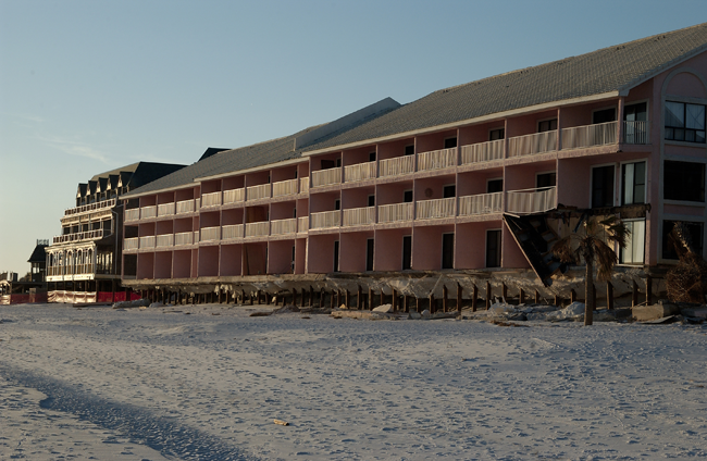 A photograph of a long, two-story condominium 