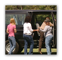She is escorting a group of women and children, not individuals. 