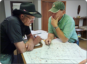 Image of two individuals reviewing documents