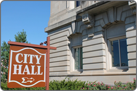 Image of building with a "City Hall" sign in front of the building.