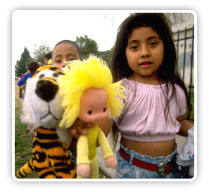 young child holding a stuffed animal