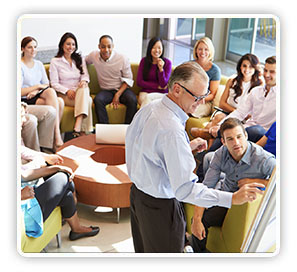 Photo of a group of people engaged in a planning meeting.