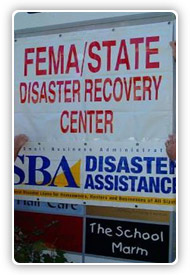 FEMA employees hanging signs to signal the opening of a Disaster Recovery Center