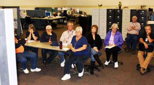 FEMA employees sitting in a classroom and watching a video